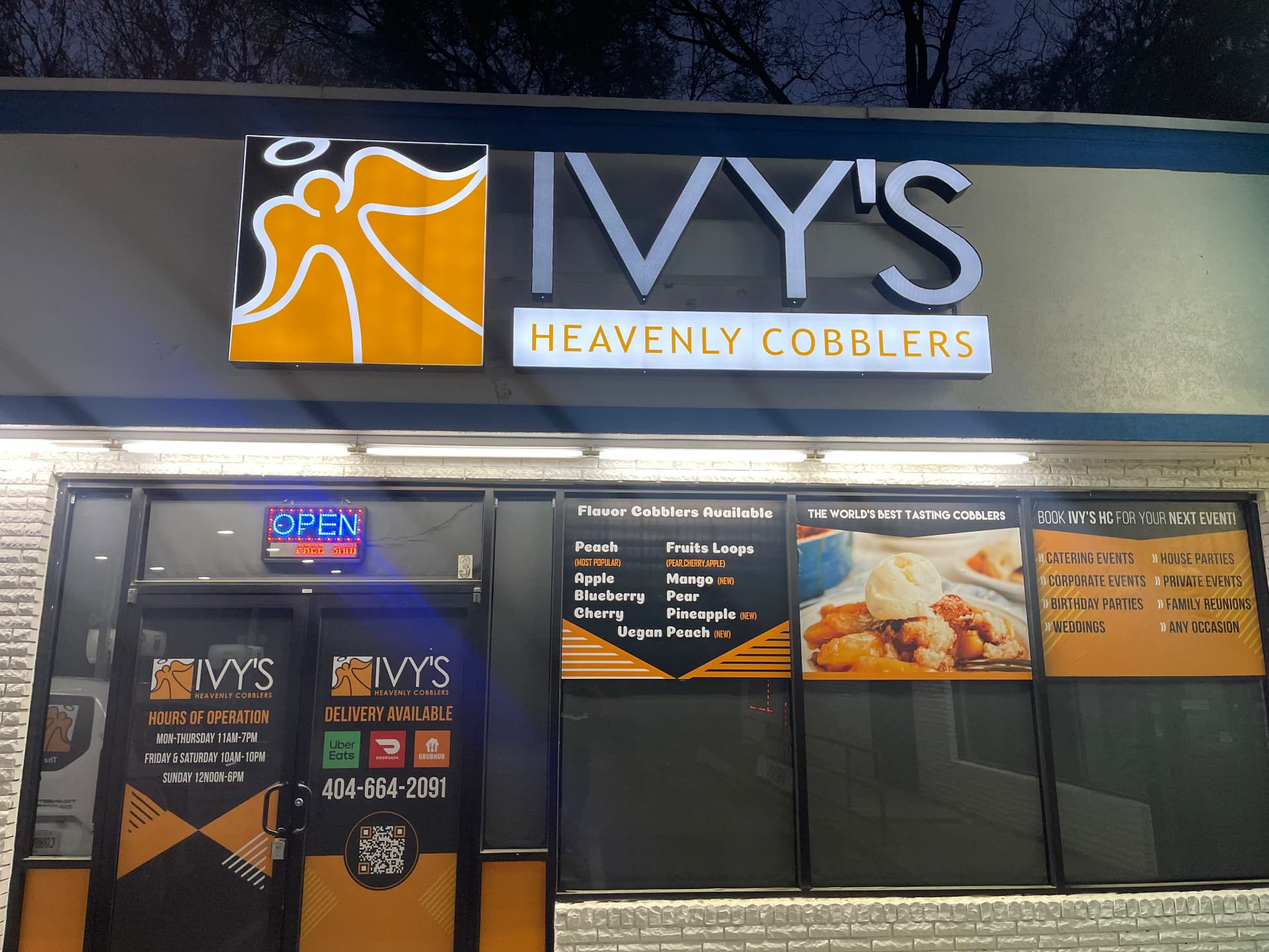 Ivy's Heavenly Cobblers storefront sign lit up at night in Atlanta