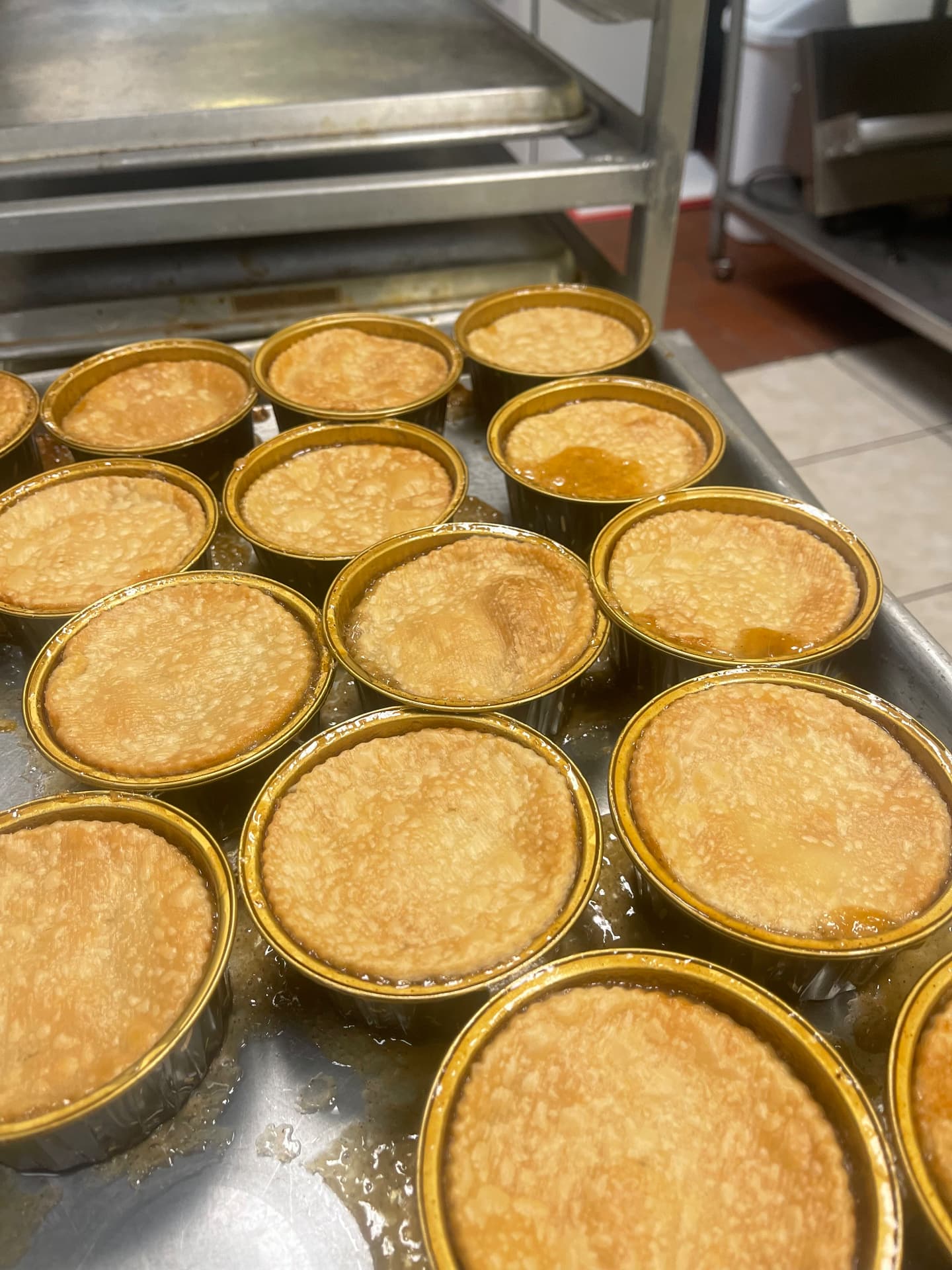Freshly baked Ivy's cobblers with golden crusts cooling on a sheet pan
