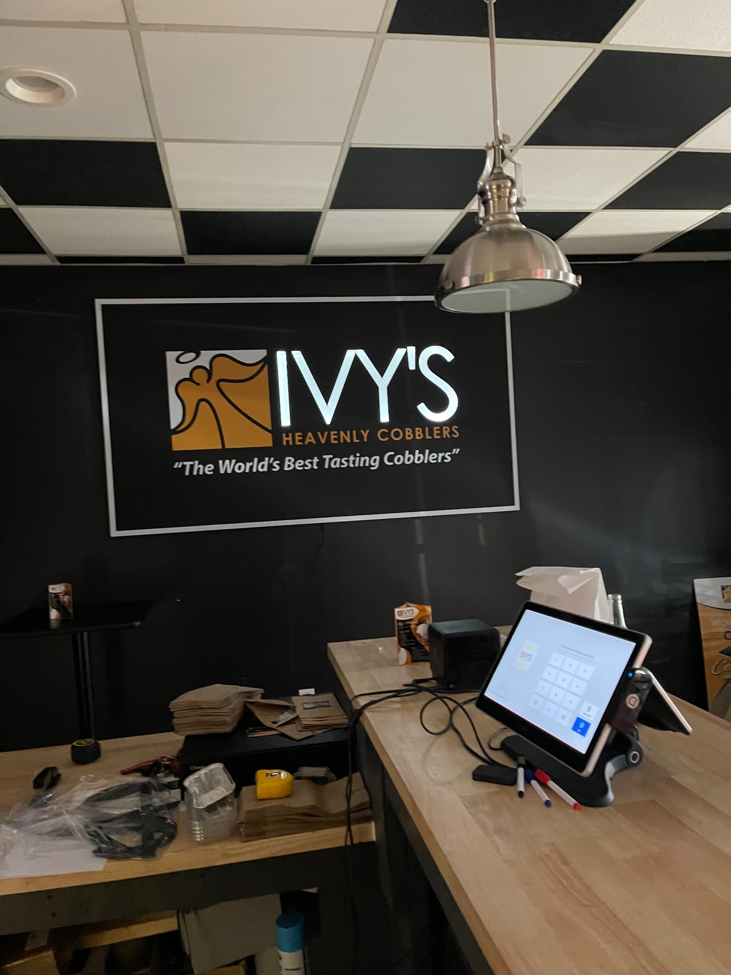 Ivy's Heavenly Cobblers counter with the lit logo wall reading The World's Best Tasting Cobblers